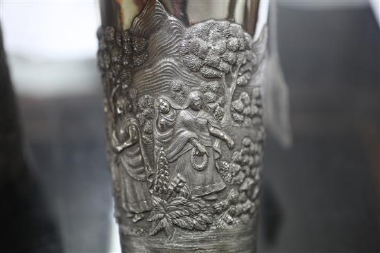 Two Indian white metal beakers, each embossed with scenes of women making offerings to Lord Shiva